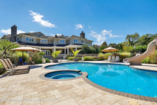 211 Cedar Ave, Long Branch, NJ 07740 - view of pool featuring a water slide, a patio, and a pool with connected hot tub