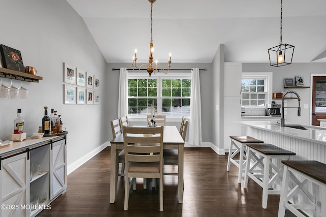 469 E Rd, Belford, NJ 07718 - dining space featuring lofted ceiling, a chandelier, dark wood finished floors, baseboards, and a bar