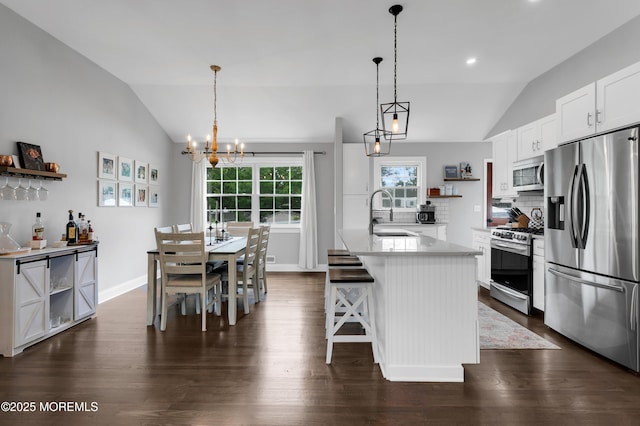 469 E Rd, Belford, NJ 07718 - kitchen with appliances with stainless steel finishes, open shelves, vaulted ceiling, a sink, and dark wood-type flooring