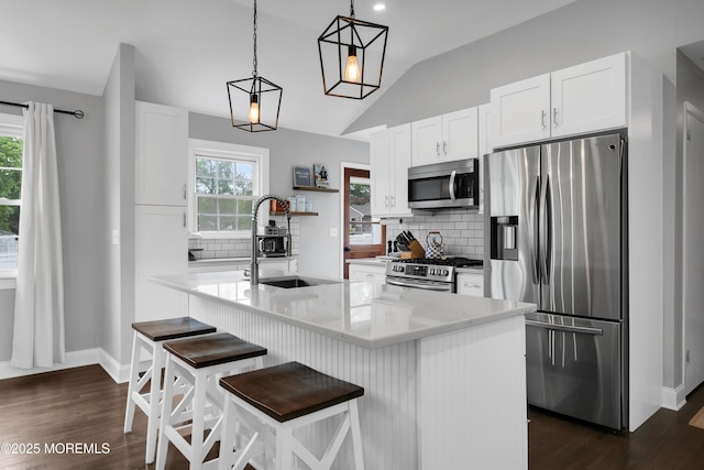 469 E Rd, Belford, NJ 07718 - kitchen featuring stainless steel appliances, a sink, lofted ceiling, backsplash, and white cabinetry