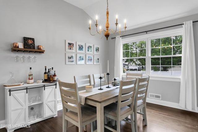 469 E Rd, Belford, NJ 07718 - dining space with a chandelier, dark wood-type flooring, lofted ceiling, baseboards, and a bar