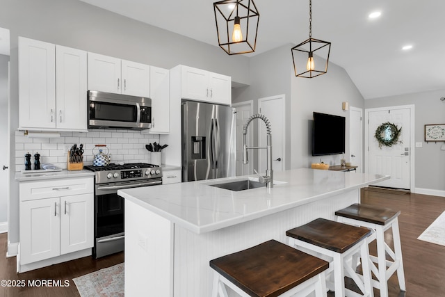 469 E Rd, Belford, NJ 07718 - kitchen with appliances with stainless steel finishes, a sink, lofted ceiling, dark wood-style flooring, and decorative backsplash