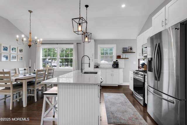 469 E Rd, Belford, NJ 07718 - kitchen with appliances with stainless steel finishes, lofted ceiling, a sink, dark wood-style floors, and backsplash