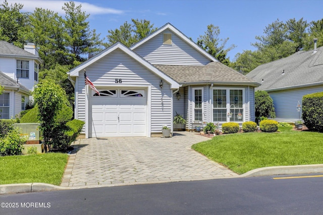 56 Hazel Dr, Freehold, NJ 07728 - view of front of house featuring an attached garage, a front yard, decorative driveway, and roof with shingles
