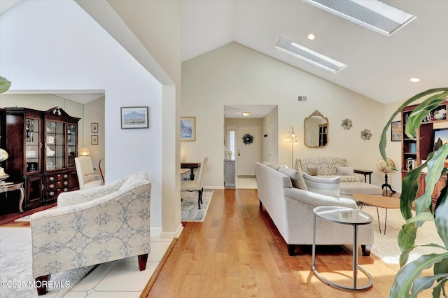 56 Hazel Dr, Freehold, NJ 07728 - living room with light wood finished floors, a skylight, high vaulted ceiling, and recessed lighting