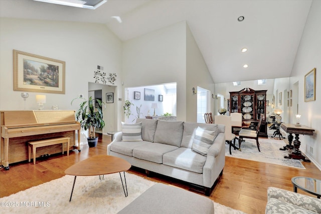56 Hazel Dr, Freehold, NJ 07728 - living room with high vaulted ceiling, light wood-style floors, and baseboards