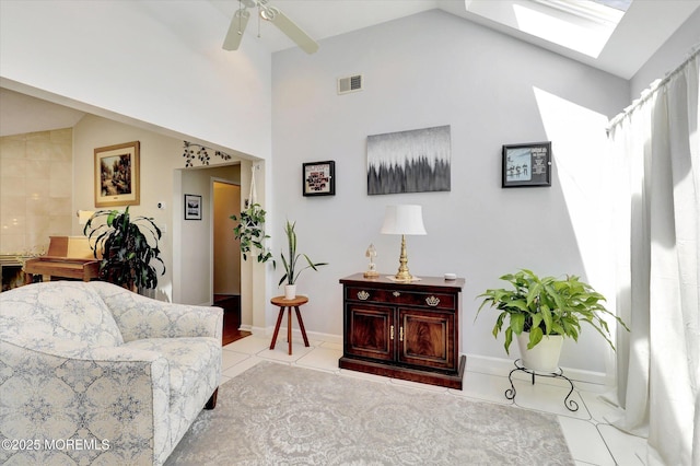 56 Hazel Dr, Freehold, NJ 07728 - tiled living room with a skylight, ceiling fan, and high vaulted ceiling