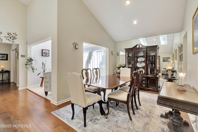 56 Hazel Dr, Freehold, NJ 07728 - dining space with high vaulted ceiling, wood finished floors, baseboards, and recessed lighting