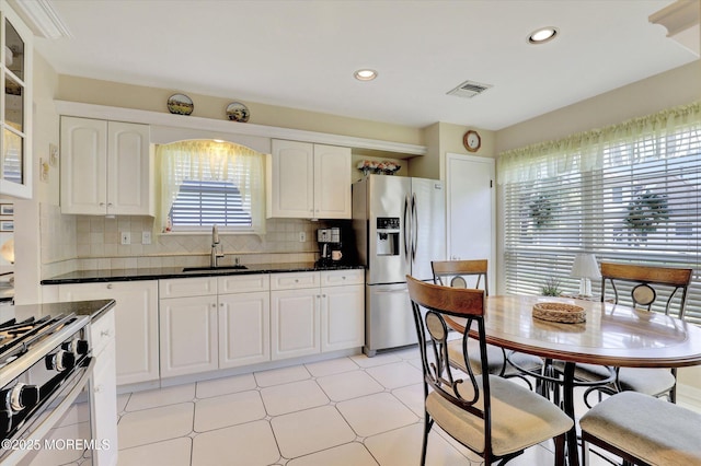 56 Hazel Dr, Freehold, NJ 07728 - kitchen featuring stainless steel appliances, a sink, glass insert cabinets, white cabinetry, and decorative backsplash