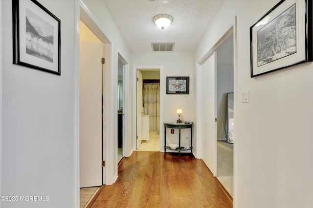 56 Hazel Dr, Freehold, NJ 07728 - corridor featuring wood finished floors and a textured ceiling
