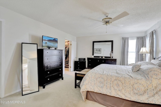 56 Hazel Dr, Freehold, NJ 07728 - bedroom featuring a spacious closet, light colored carpet, a textured ceiling, a closet, and ceiling fan