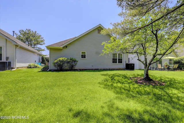 56 Hazel Dr, Freehold, NJ 07728 - back of property with central AC and a lawn