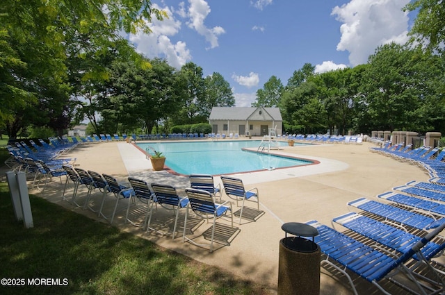 56 Hazel Dr, Freehold, NJ 07728 - community pool with a patio and view of wooded area