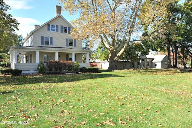 56 Hazel Dr, Freehold, NJ 07728 - view of front of home featuring a chimney, a front lawn, and a porch