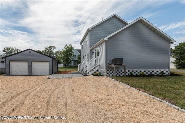 110 Island Rd, Toms River, NJ 08753 - view of side of property featuring a detached garage, an outbuilding, a lawn, and central AC unit