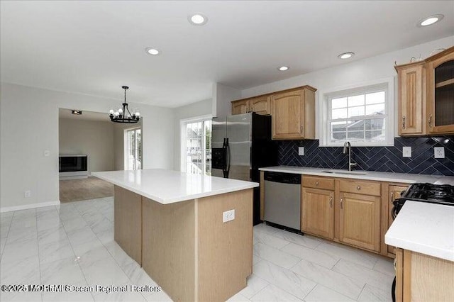 110 Island Rd, Toms River, NJ 08753 - kitchen featuring stainless steel appliances, a sink, a center island, light countertops, and decorative backsplash