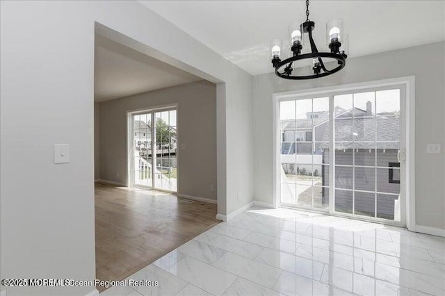 110 Island Rd, Toms River, NJ 08753 - unfurnished dining area with a chandelier, marble finish flooring, and baseboards