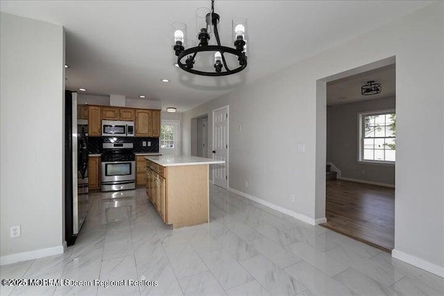 110 Island Rd, Toms River, NJ 08753 - kitchen featuring appliances with stainless steel finishes, baseboards, a chandelier, light marble finish floors, and recessed lighting