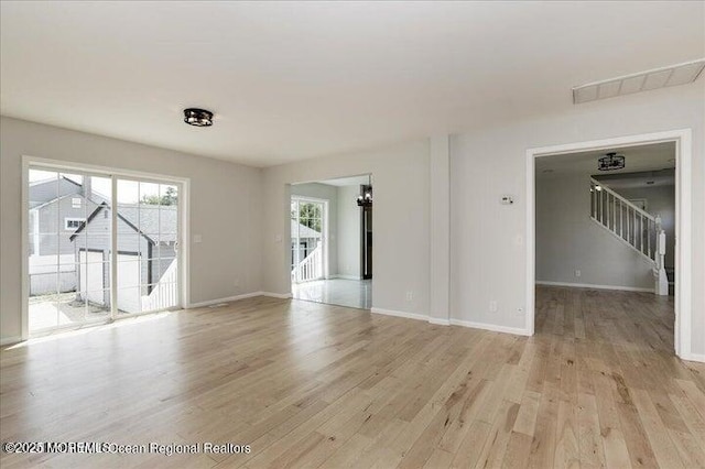 110 Island Rd, Toms River, NJ 08753 - spare room featuring stairway, light wood-type flooring, and baseboards