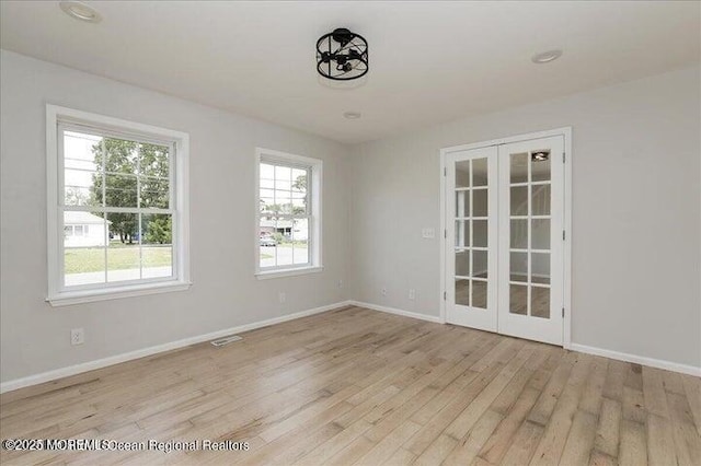 110 Island Rd, Toms River, NJ 08753 - empty room featuring french doors, light wood finished floors, and baseboards