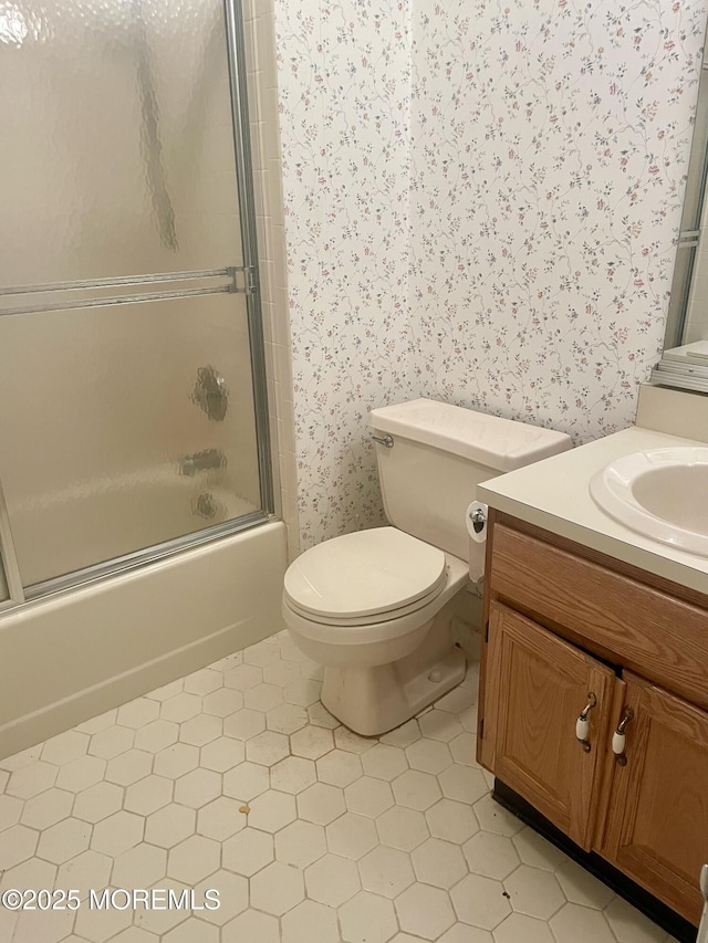 57 Pape Dr, Atlantic Highlands, NJ 07716 - bathroom with wallpapered walls, vanity, toilet, bath / shower combo with glass door, and tile patterned floors