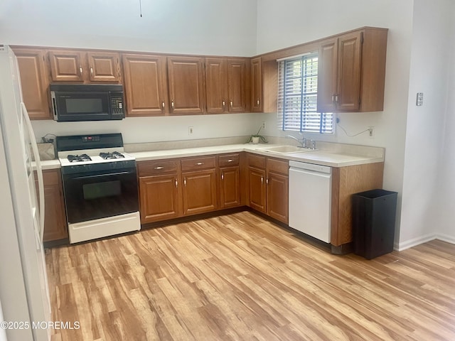 57 Pape Dr, Atlantic Highlands, NJ 07716 - kitchen with white appliances, light wood-style flooring, a sink, light countertops, and brown cabinets