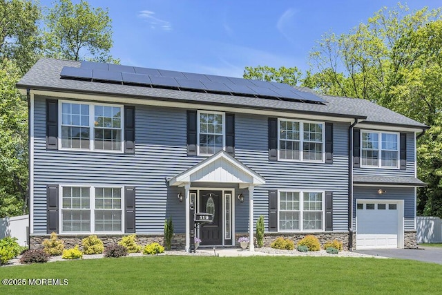 119 Darien Rd, Howell, NJ 07731 - view of front of house with stone siding, a front yard, and solar panels
