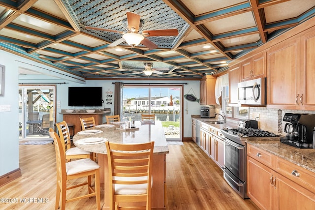 125 Bloomfield Rd, Barnegat, NJ 08005 - kitchen featuring stainless steel appliances, ceiling fan, light stone counters, light wood-type flooring, and coffered ceiling