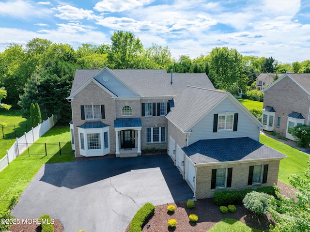 64 Sage St, Holmdel, NJ 07733 - view of front of property featuring a shingled roof, brick siding, and driveway