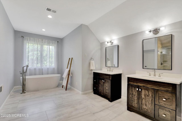 64 Sage St, Holmdel, NJ 07733 - bathroom featuring two vanities, a freestanding bath, baseboards, vaulted ceiling, and recessed lighting