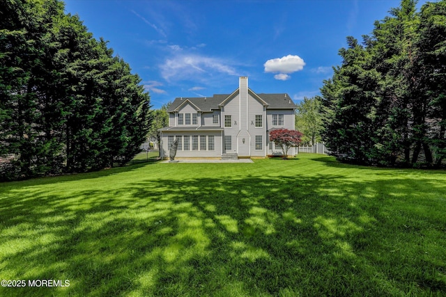 64 Sage St, Holmdel, NJ 07733 - back of house with a chimney and a yard