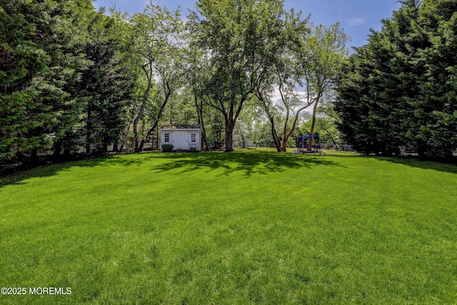 64 Sage St, Holmdel, NJ 07733 - view of green lawn with a playground and an outbuilding