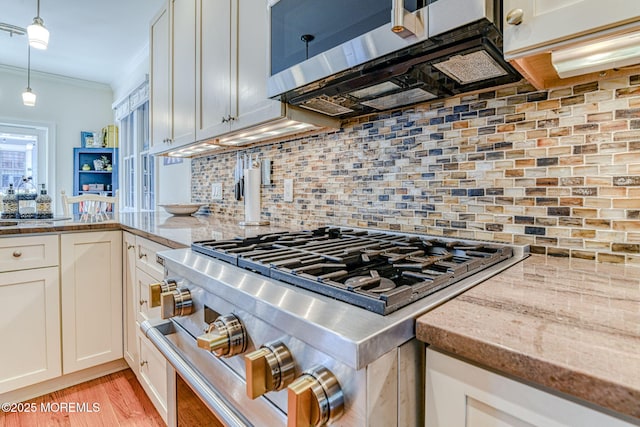 78 Cookman Ave, Ocean Grove, NJ 07756 - kitchen with stainless steel appliances, crown molding, backsplash, white cabinetry, and pendant lighting