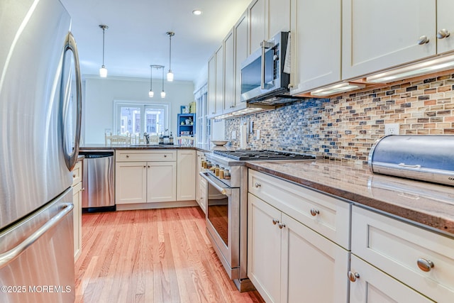 78 Cookman Ave, Ocean Grove, NJ 07756 - kitchen with appliances with stainless steel finishes, a sink, light wood-type flooring, backsplash, and ornamental molding