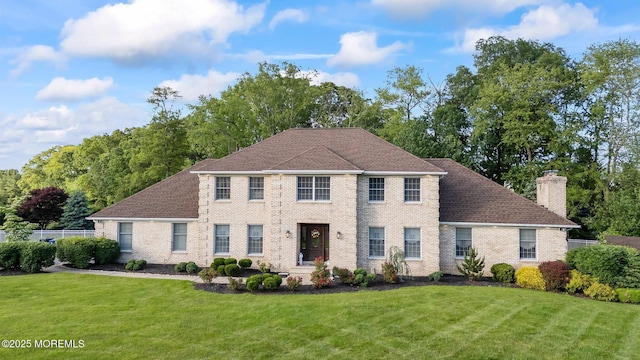 21 Windswept Ln, Freehold, NJ 07728 - view of front facade featuring a chimney, brick siding, and roof with shingles