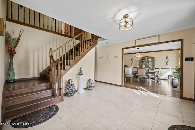 21 Windswept Ln, Freehold, NJ 07728 - stairs with a chandelier, tile patterned flooring, and baseboards