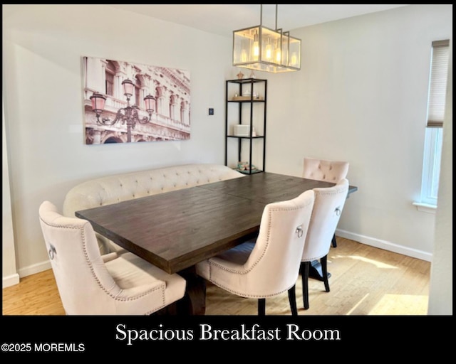 123 France St, Toms River, NJ 08753 - dining space featuring wood finished floors, baseboards, breakfast area, and a chandelier