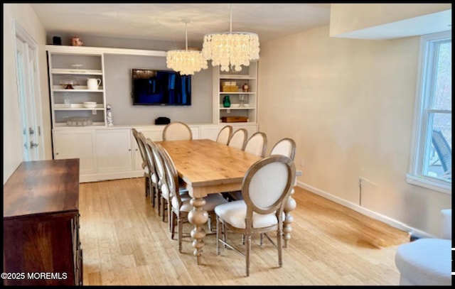 123 France St, Toms River, NJ 08753 - dining space featuring a chandelier, light wood finished floors, and baseboards