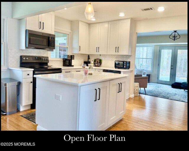 123 France St, Toms River, NJ 08753 - kitchen with stainless steel range with electric cooktop, light wood-style floors, healthy amount of natural light, white cabinets, and recessed lighting