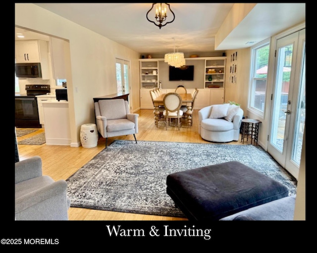 123 France St, Toms River, NJ 08753 - living area with wood finished floors, a chandelier, plenty of natural light, and built in features
