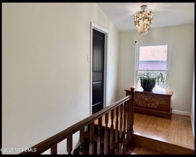 123 France St, Toms River, NJ 08753 - staircase featuring wood finished floors, a chandelier, and baseboards