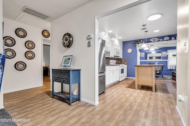 4 Delaware Way Unit A, Whiting, NJ 08759 - kitchen featuring white appliances, light wood-type flooring, white cabinets, baseboards, and recessed lighting