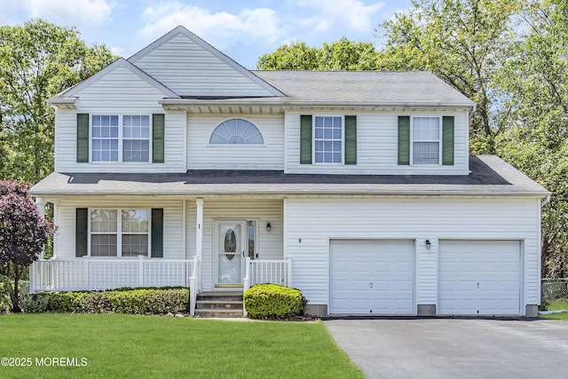 1 Overlook Ct, Manchester, NJ 08759 - traditional-style home with an attached garage, covered porch, driveway, and a front lawn
