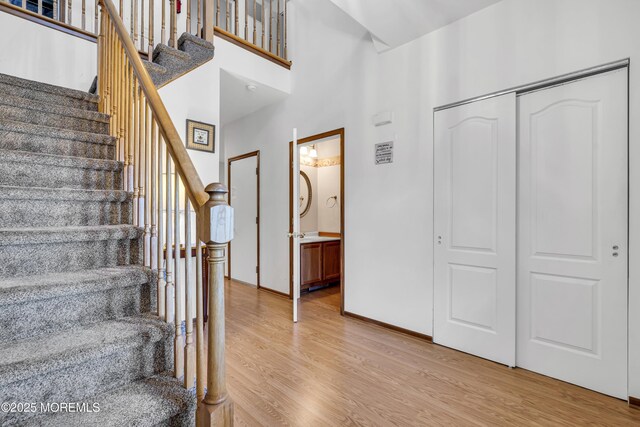 1 Overlook Ct, Manchester, NJ 08759 - entryway with light wood-type flooring, a towering ceiling, stairs, and baseboards