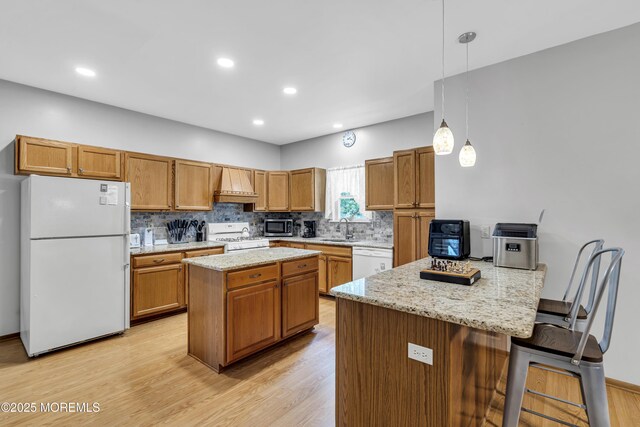 1 Overlook Ct, Manchester, NJ 08759 - kitchen with white appliances, a sink, a peninsula, light wood finished floors, and custom exhaust hood