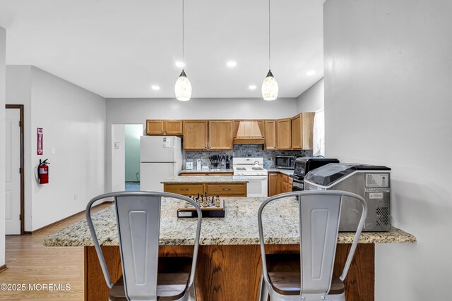 1 Overlook Ct, Manchester, NJ 08759 - kitchen with white appliances, custom range hood, light wood-type flooring, decorative backsplash, and a peninsula