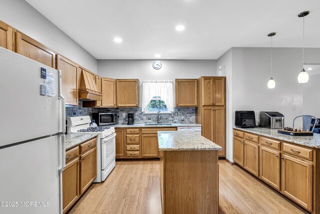 1 Overlook Ct, Manchester, NJ 08759 - kitchen with white appliances, custom range hood, light wood-type flooring, decorative backsplash, and a center island