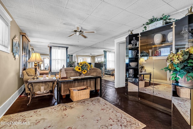54 Wall St, West Long Branch, NJ 07764 - living area featuring a ceiling fan, baseboards, and a drop ceiling
