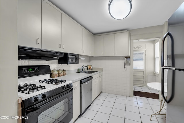 54 Wall St, West Long Branch, NJ 07764 - kitchen with appliances with stainless steel finishes, under cabinet range hood, light countertops, light tile patterned floors, and a sink
