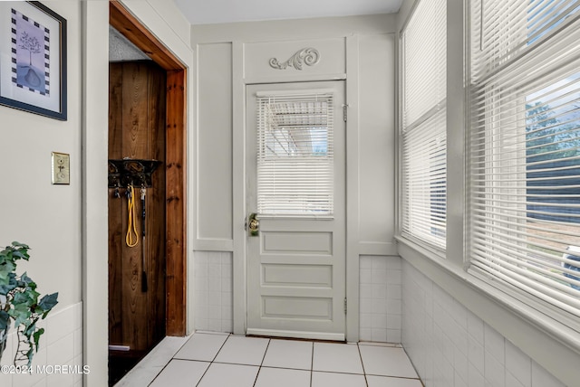 54 Wall St, West Long Branch, NJ 07764 - entryway featuring healthy amount of natural light, a wainscoted wall, and tile patterned flooring